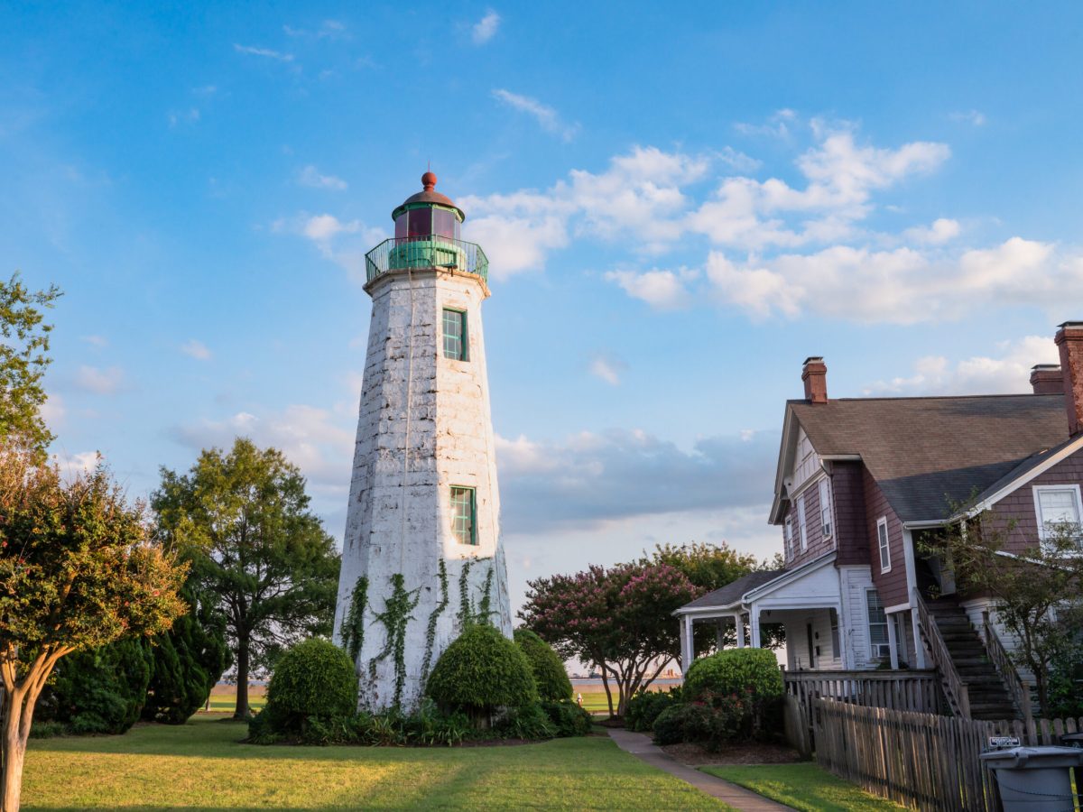 a small clock tower in front of a house