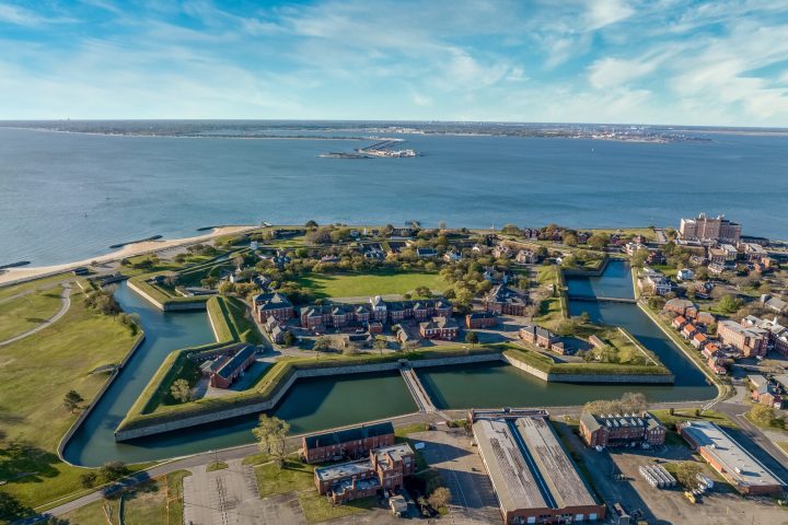 a large body of water with a city in the background
