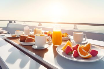 a plate of food and a glass of orange juice